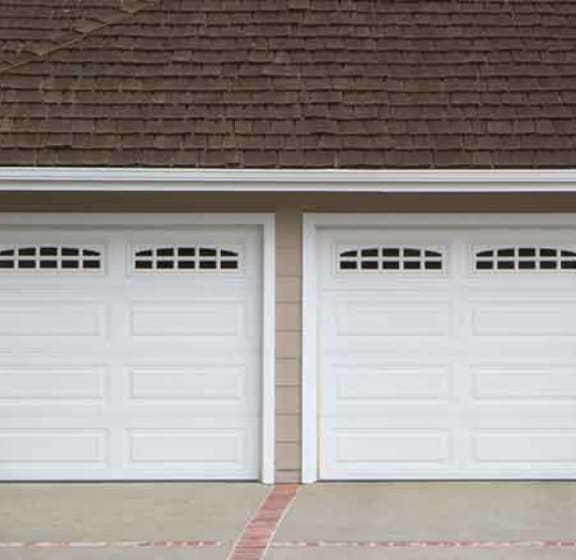 a house with three garages and an american flag