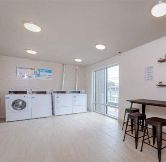 A laundry room with washers and dryers.