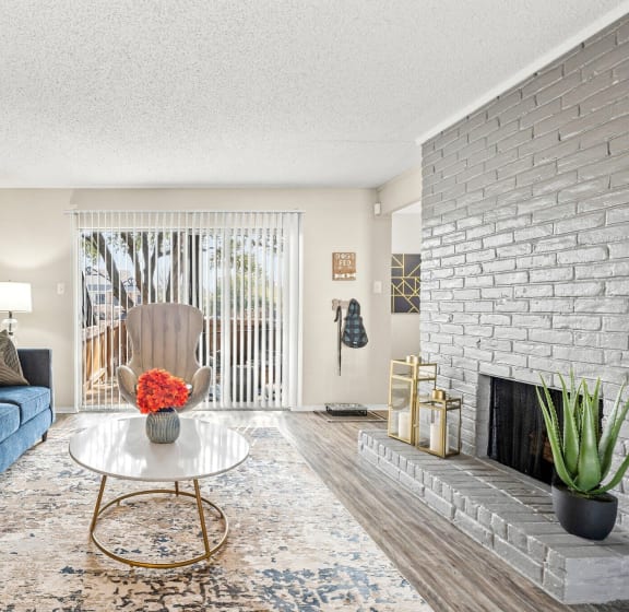 a living room with a blue couch and a fireplace at Keller Oaks, Carrollton, TX 75006