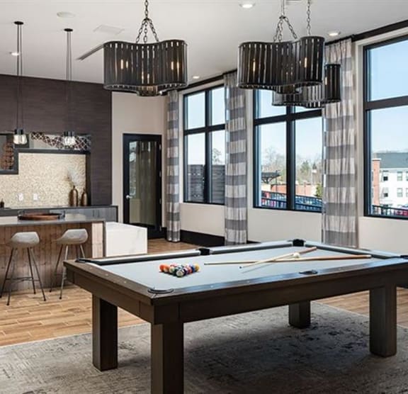 a living room with a pool table and a bar at The Flats at Southlawn Apartments, Georgia, 30046