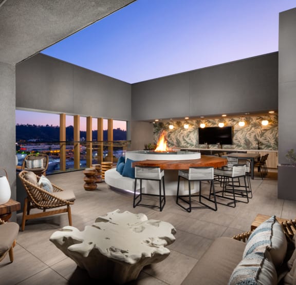 a man and woman laughing and drinking wine on a rooftop at night  at VORA LUX, San Diego, CA 92120