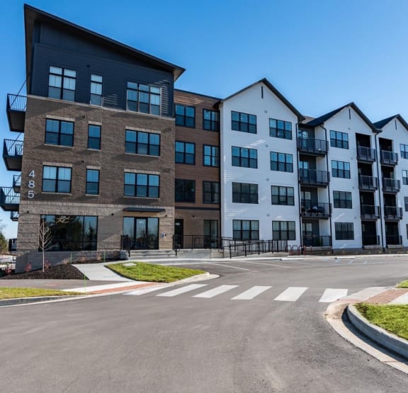a large apartment building with a street in front of it