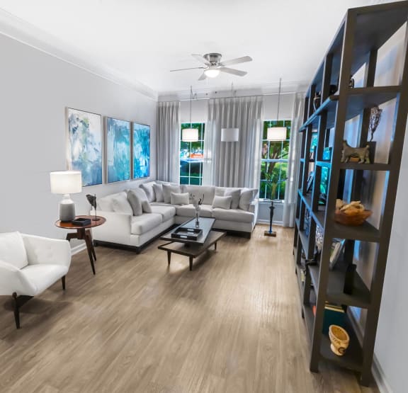 a living room with white couches and a couch