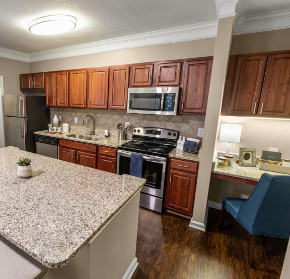 full kitchen with granite countertops and stainless steel appliances at the preserve at great heights