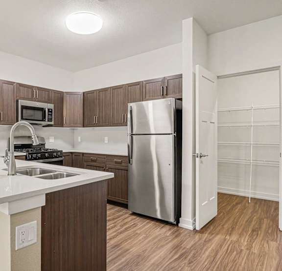 a kitchen with a breakfast bar and huge pantry at Meadowbrooke Apartment Homes, Grand Rapids, MI