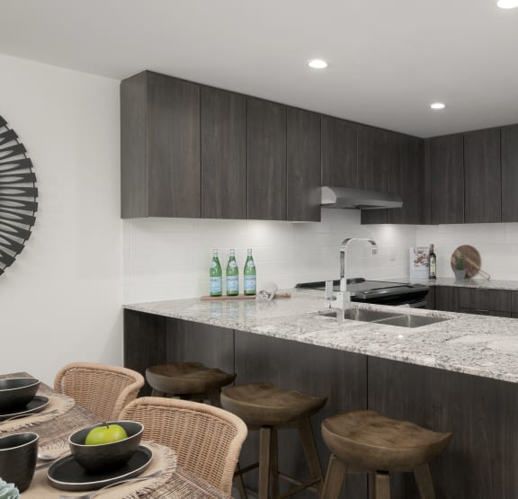 a kitchen with a marble counter top and a sink
