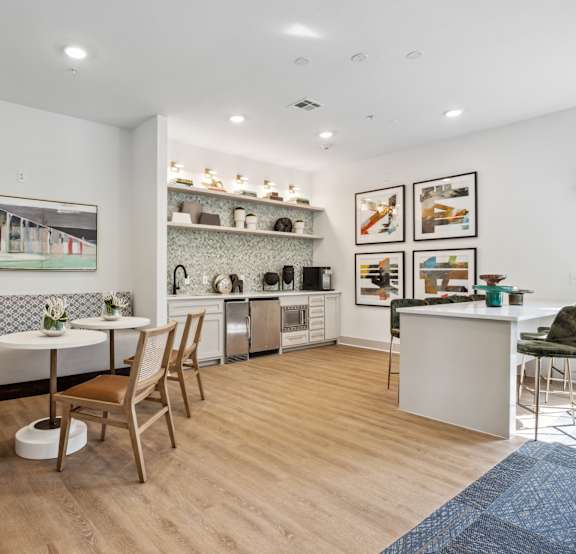 A kitchen with a dining table and chairs.