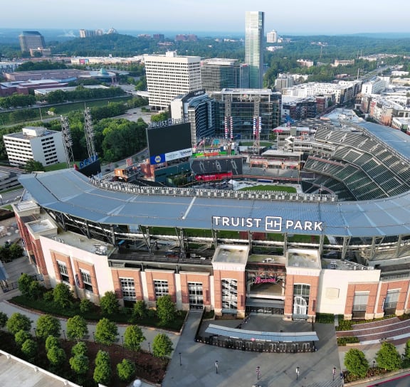 an aerial view of trust id park with the downtown skyline in the background