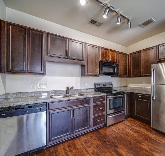 a kitchen with stainless steel appliances and wooden cabinets
