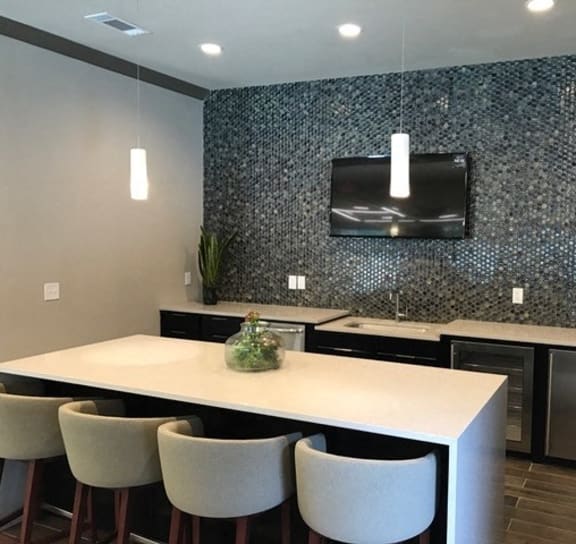 a lobby with yellow chairs and tables and a tv