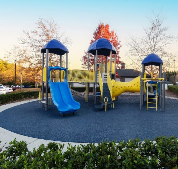 a playground with a yellow and blue swing set