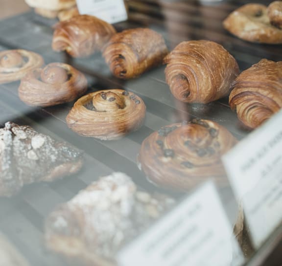 a selection of pastries in a glass case