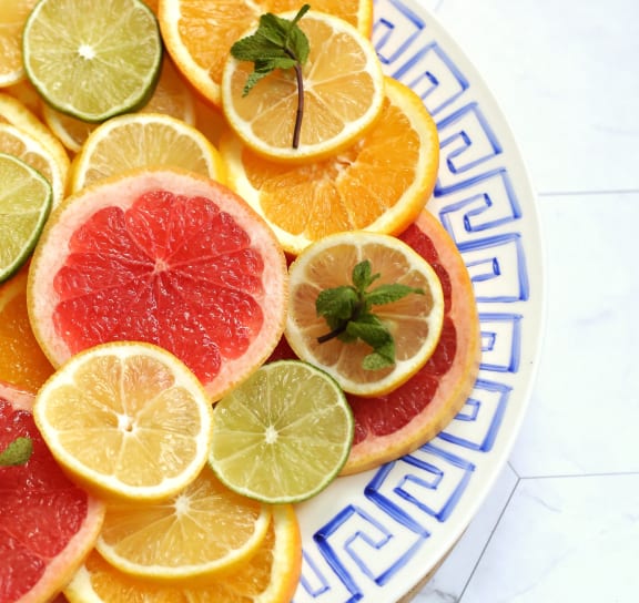 a plate of citrus fruit on a wooden cutting board
