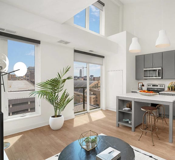 a living room with a kitchen and a large window