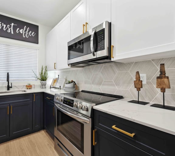 a kitchen with white countertops and black cabinets