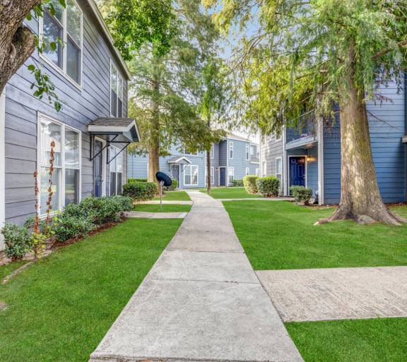 Whitney Manor Apartments in Gretna, LA photo of community buildings with greenery in between