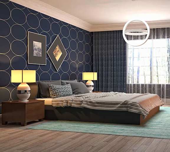 A bedroom with a large bed, two lamps, and pictures on the wall.