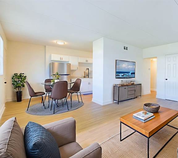 A living room with a brown sofa and a wooden coffee table.
