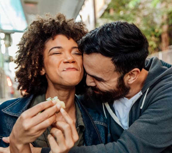 a man and a woman eating food together