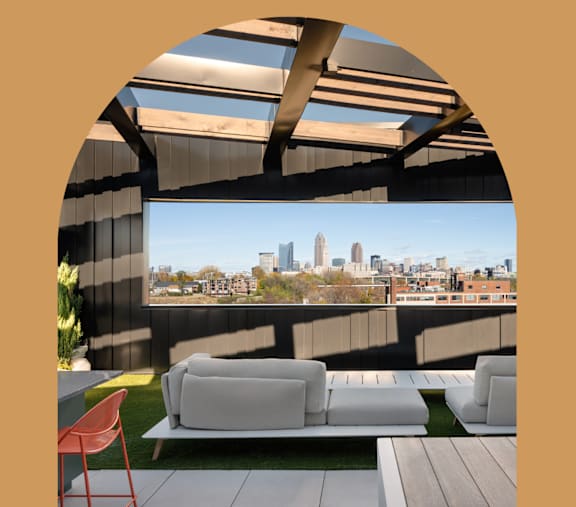 A modern outdoor seating area with a view of the city skyline.at The Park Apartments, Cleveland , OH