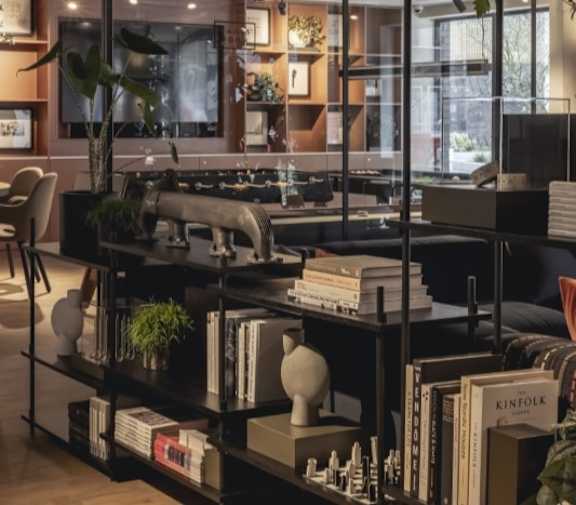 A black bookshelf filled with books and decorative items.