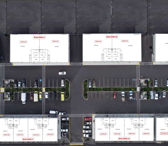 a large white building with a parking lot in front of it