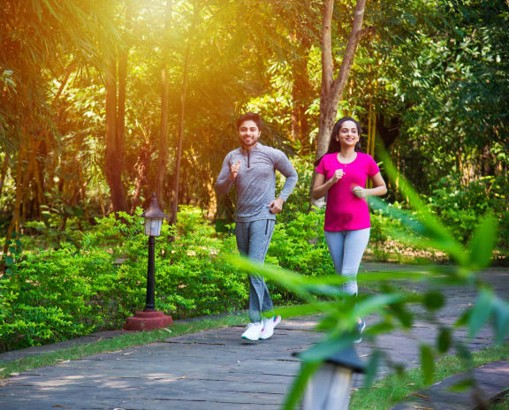 a couple jogging in a park