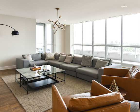A living room with a green chair and a white sofa.at 929 Richmond Apartments, Ottawa, K2B 6R1