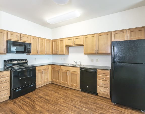 a living room with a kitchen and a balcony