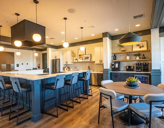 A modern kitchen with a large island and bar stools.