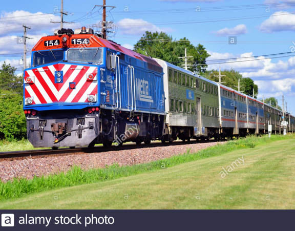 a train traveling down the tracks in the country