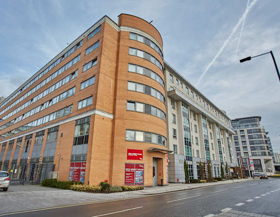 A large red brick building with a curved corner.