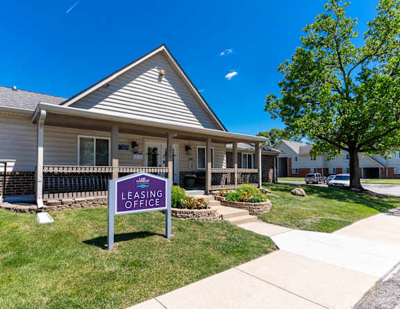 A leasing office is located in a building with a porch at Lake Camelot Apartments, Indianapolis, 46268.