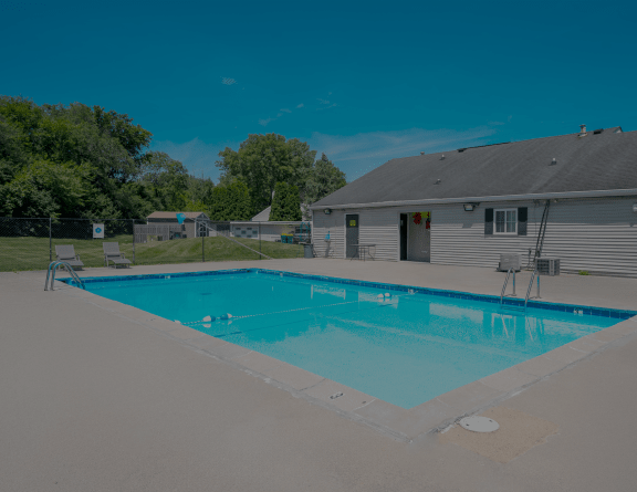 a swimming pool in front of a house