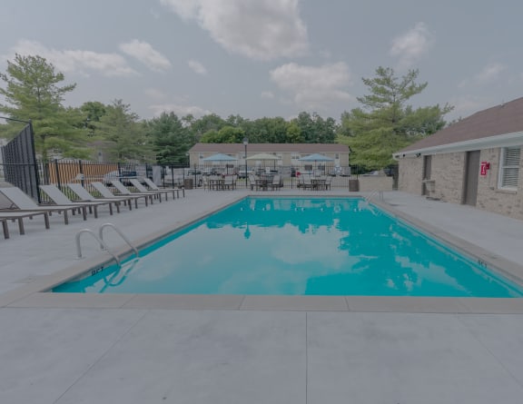 our resort style swimming pool is next to our club house with chairs