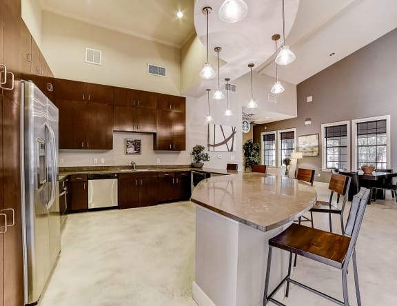 a large kitchen with a large center island with a marble countertop