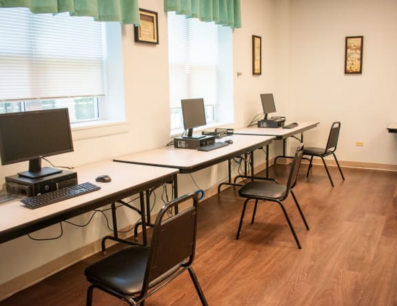a row of desks with computers on them
