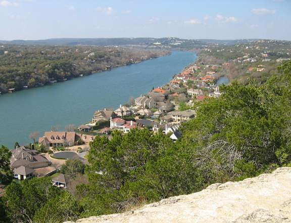 A river flows through a town nestled in the hills.