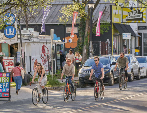 people riding bikes on a busy city street