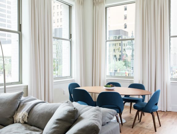 a living room with a couch and a table and chairs