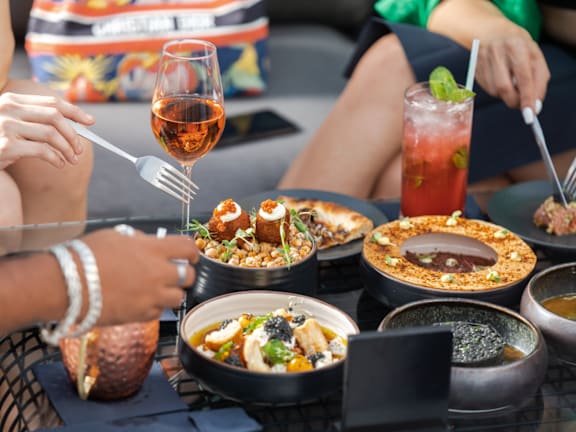 A group of people enjoying a meal together at a restaurant.