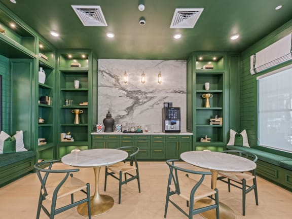 a cafe with tables and chairs and green cabinets
