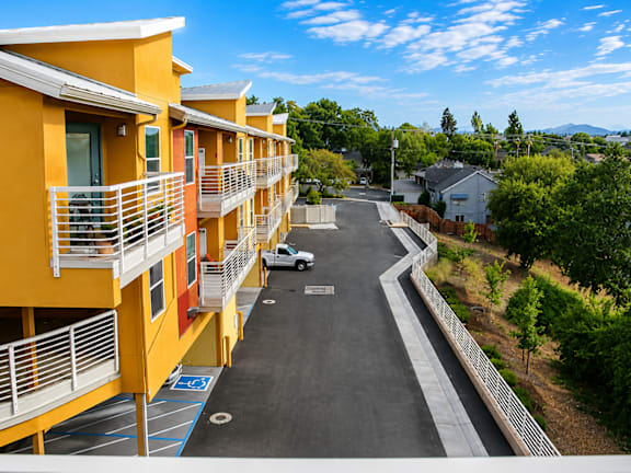 A balcony with a view of a town and trees.