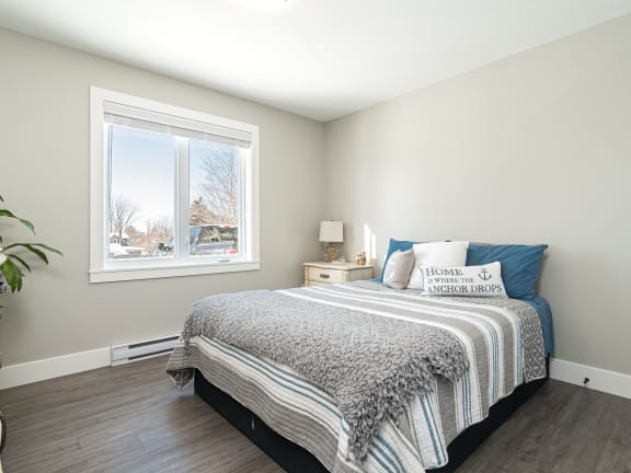 a bedroom with a bed and a window