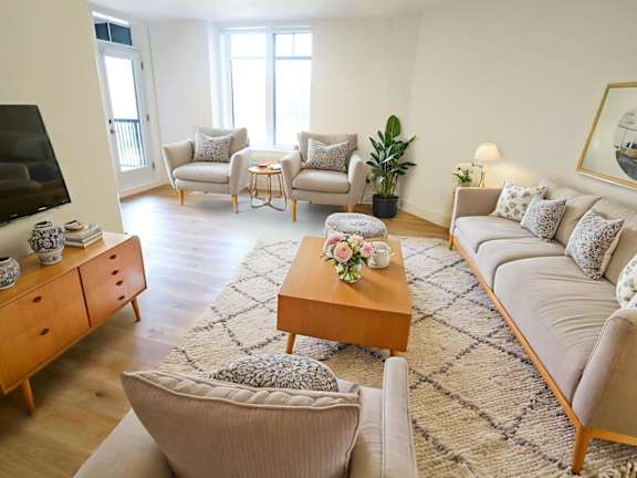 a living room with two chairs and a table and a window