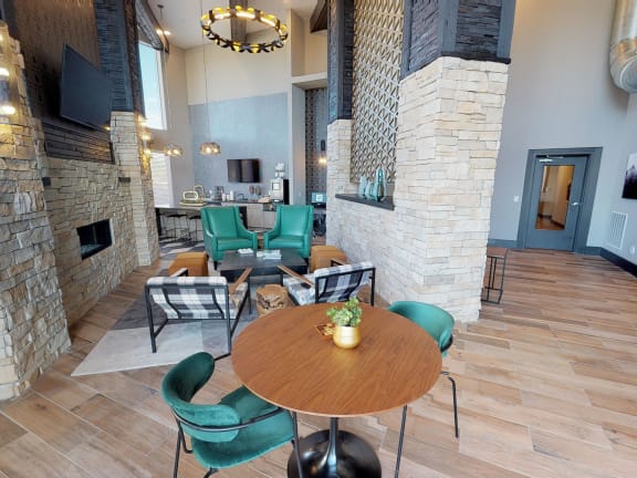 a dining area with a table and chairs next to a fireplace