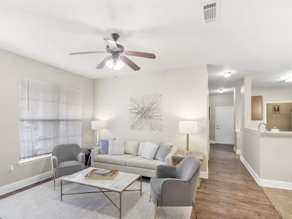 a living room with a couch and chairs and a table  at Quail Ridge Highlands Apartment Homes, Bartlett, Tennessee