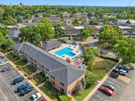 an overhead view of a building with a swimming pool