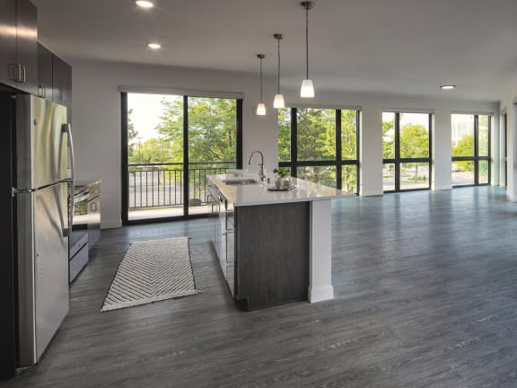 a large open kitchen and living room with a view of the outdoors