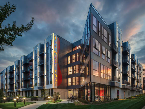 a rendering of a large building with a sunset in the background